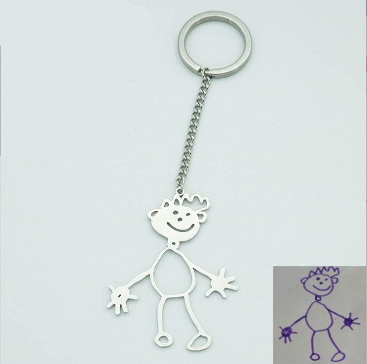 Metal keychain shaped like a stick figure with a smiling face on a light grey background.