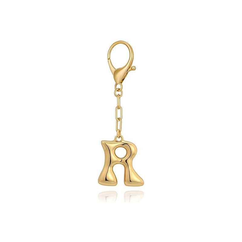 Gold letter 'R' keychain with clasp on a white background