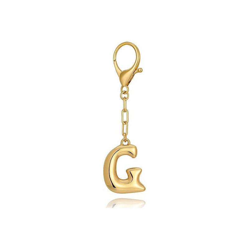 Gold letter 'G' keychain with clasp on a white background