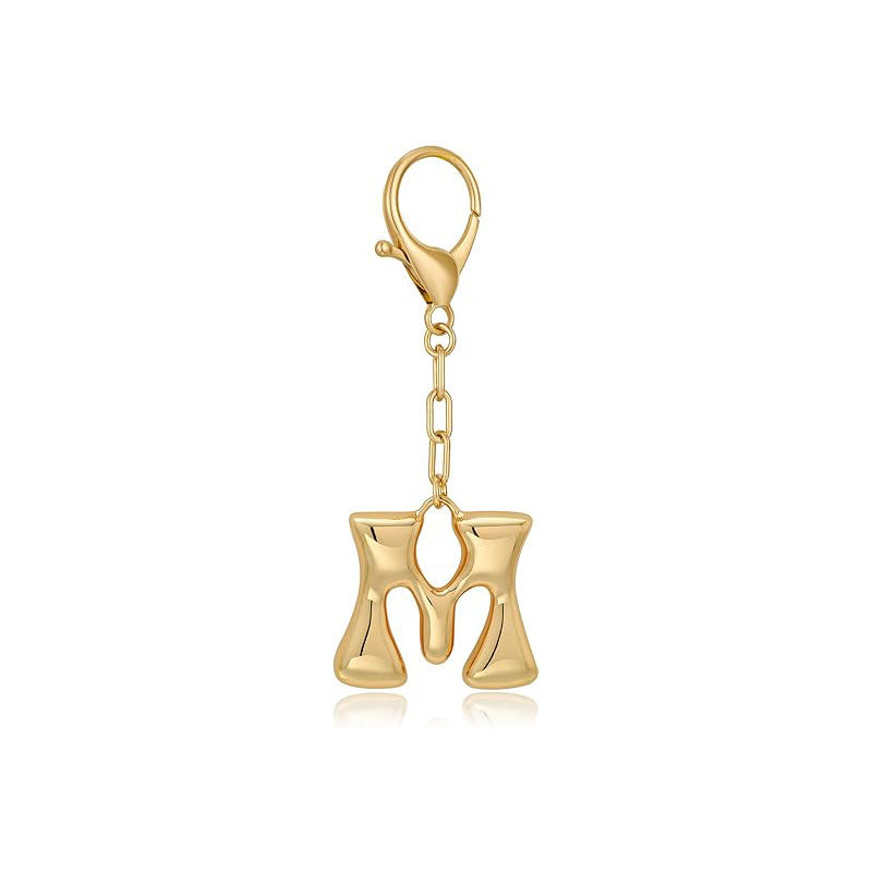 Gold letter 'M' keychain with clasp on a white background