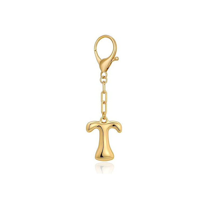 Gold letter 'T' keychain with clasp on a white background