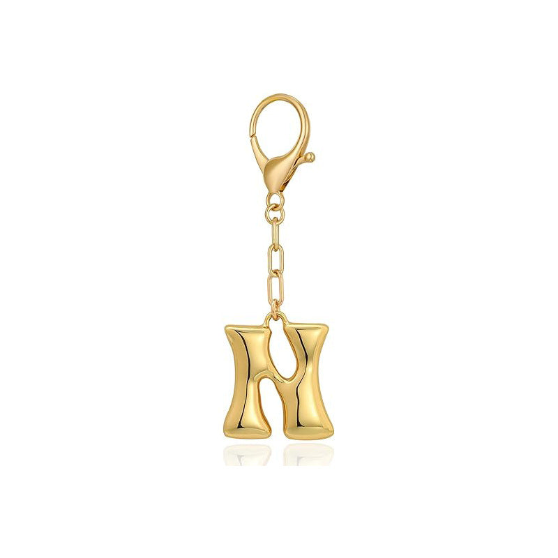 Gold letter 'N' keychain with clasp on a white background