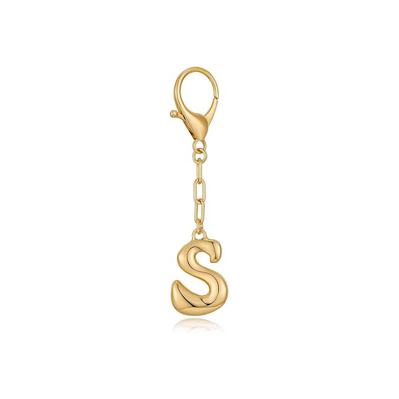 Gold letter 'S' keychain with clasp on a white background