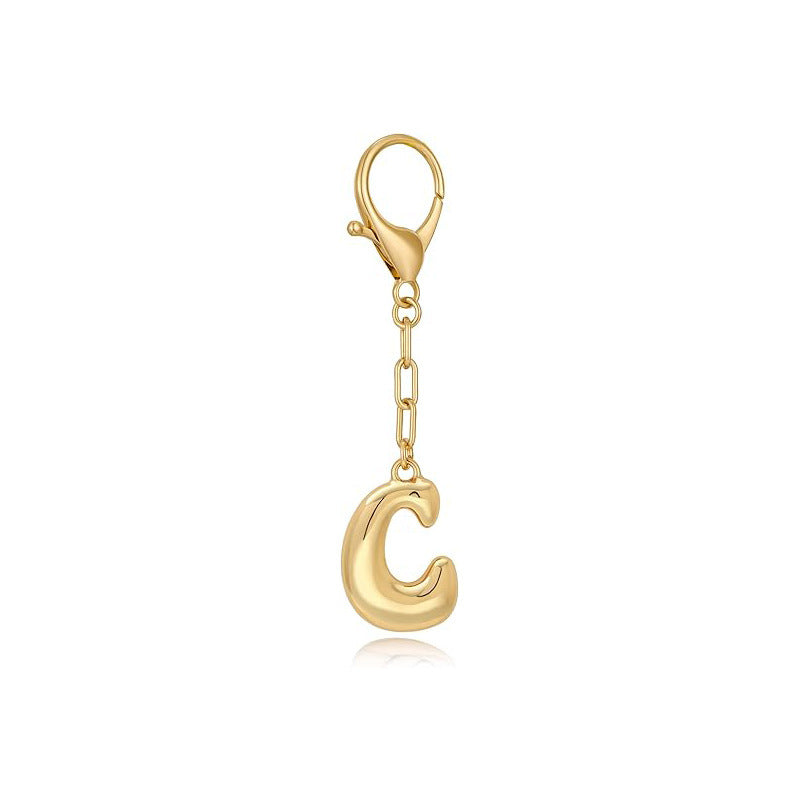 Gold letter 'C' keychain with clasp on a white background