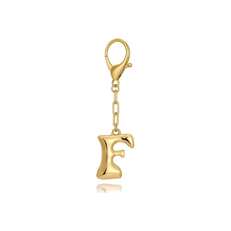 Gold letter 'F' keychain with clasp on a white background