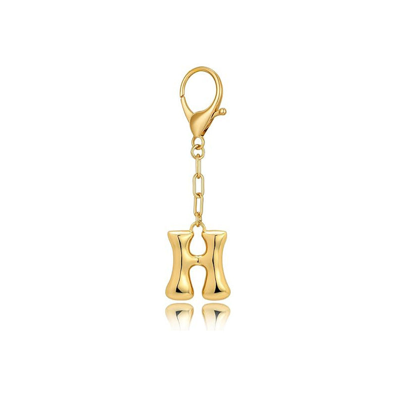 Gold letter 'H' keychain with clasp on a white background