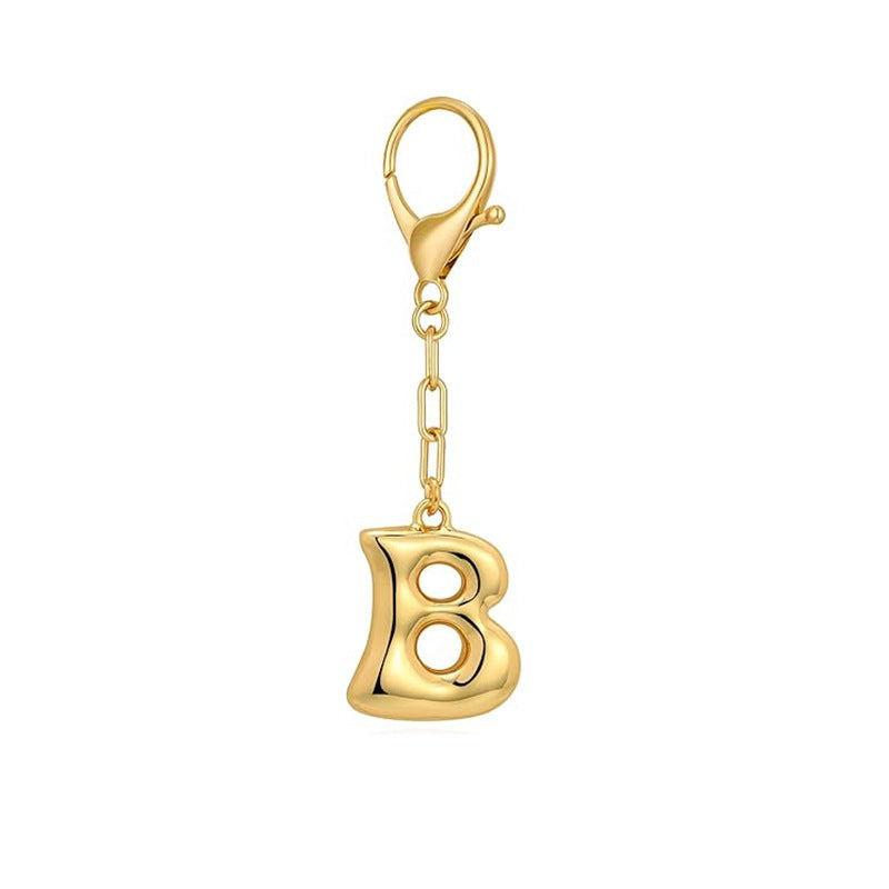 Gold letter 'B' keychain with clasp on a white background