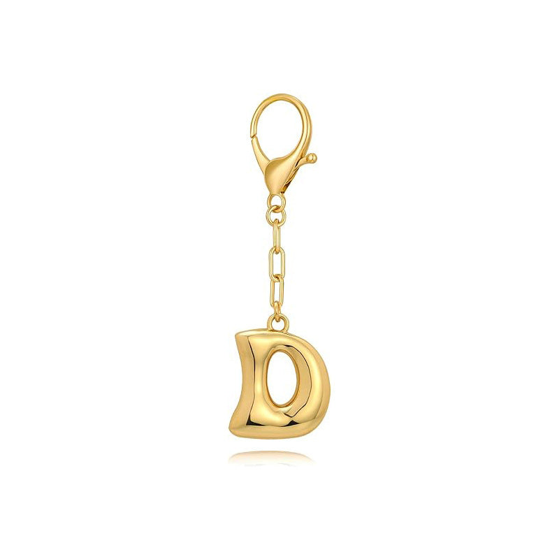 Gold letter 'D' keychain with clasp on a white background