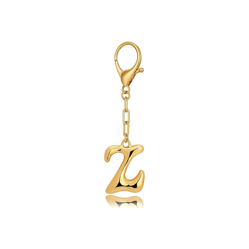Gold letter 'Z' keychain with clasp on a white background