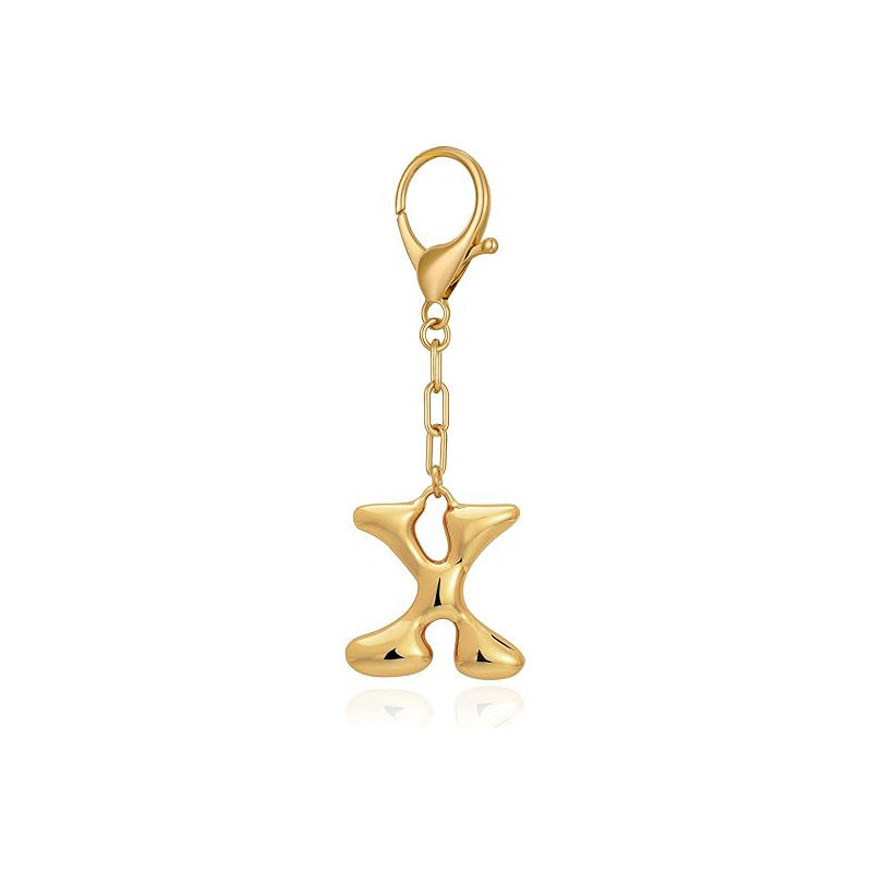 Gold letter 'X' keychain with clasp on a white background